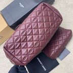 Quilted maroon handbag with structured sides and interior view over a matching pouch