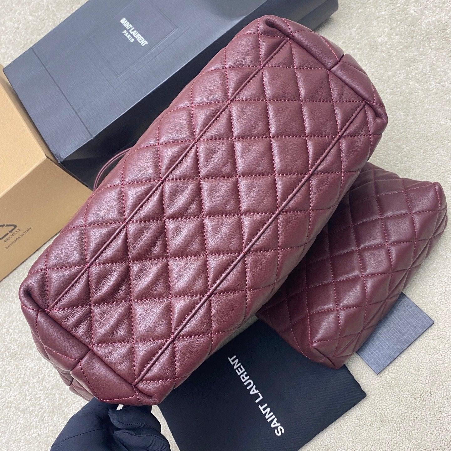 Quilted maroon handbag with structured sides and interior view over a matching pouch
