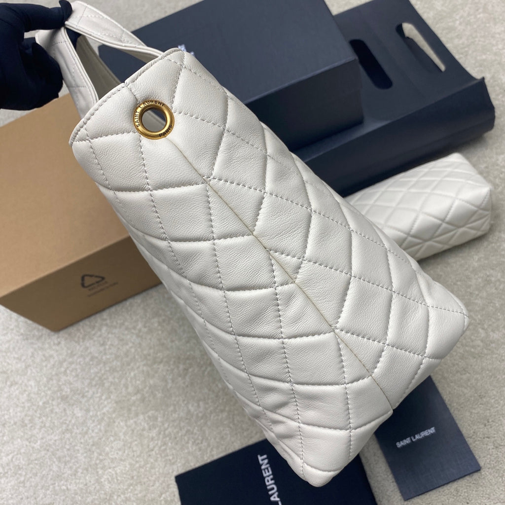 YSL white quilted bag with gold ring hardware at strap opening