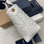YSL white quilted bag with gold ring hardware at strap opening