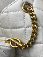 YSL white quilted bag close-up of gold chain and zipper pull