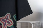 Black T-shirt sleeve with partial multicolor flower graphic