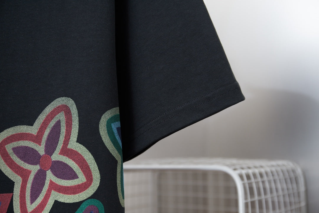 Black T-shirt sleeve with partial multicolor flower graphic