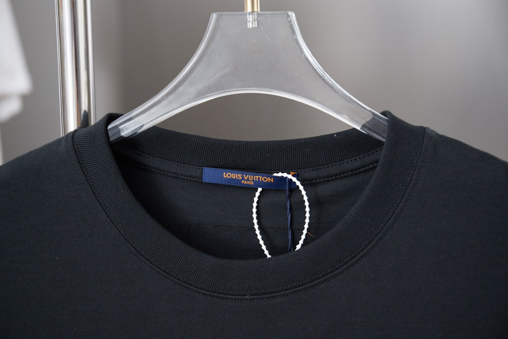 Black crewneck T-shirt close-up with interior brand tag at neckline