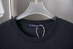 Black crewneck T-shirt close-up with interior brand tag at neckline