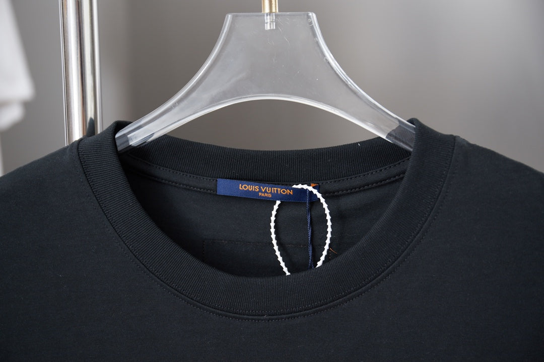 Black crewneck T-shirt close-up with interior brand tag at neckline