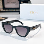 Dior sunglasses with dark frame and violet-tinted lenses.