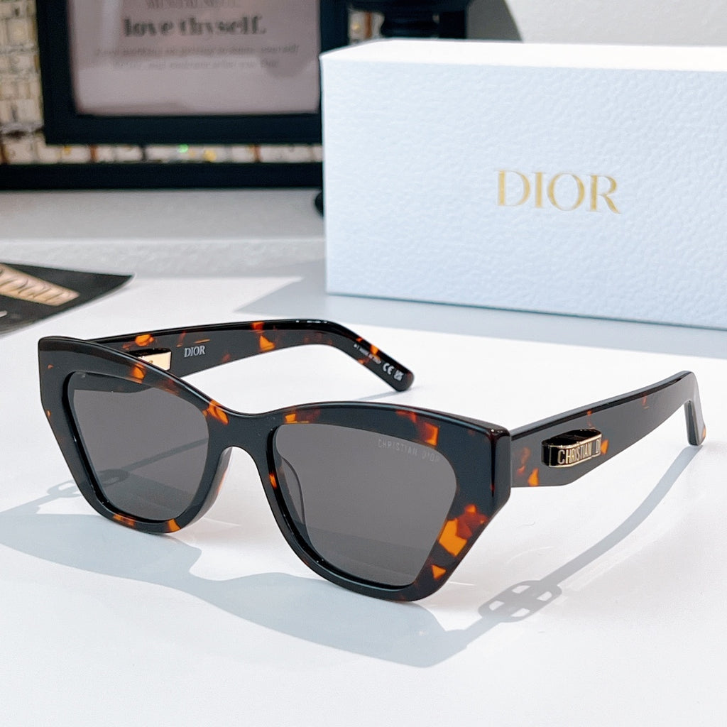 Dior sunglasses with dark frame and orange tortoiseshell accents.