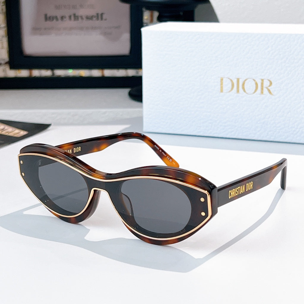 Sunglasses with tortoiseshell frames, gold trim, and dark lenses