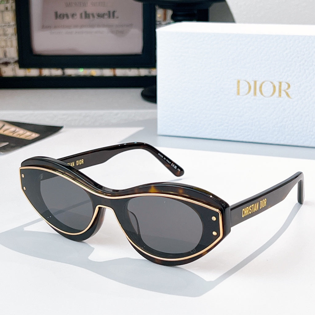 Sunglasses with black frames, gold trim, and dark lenses
