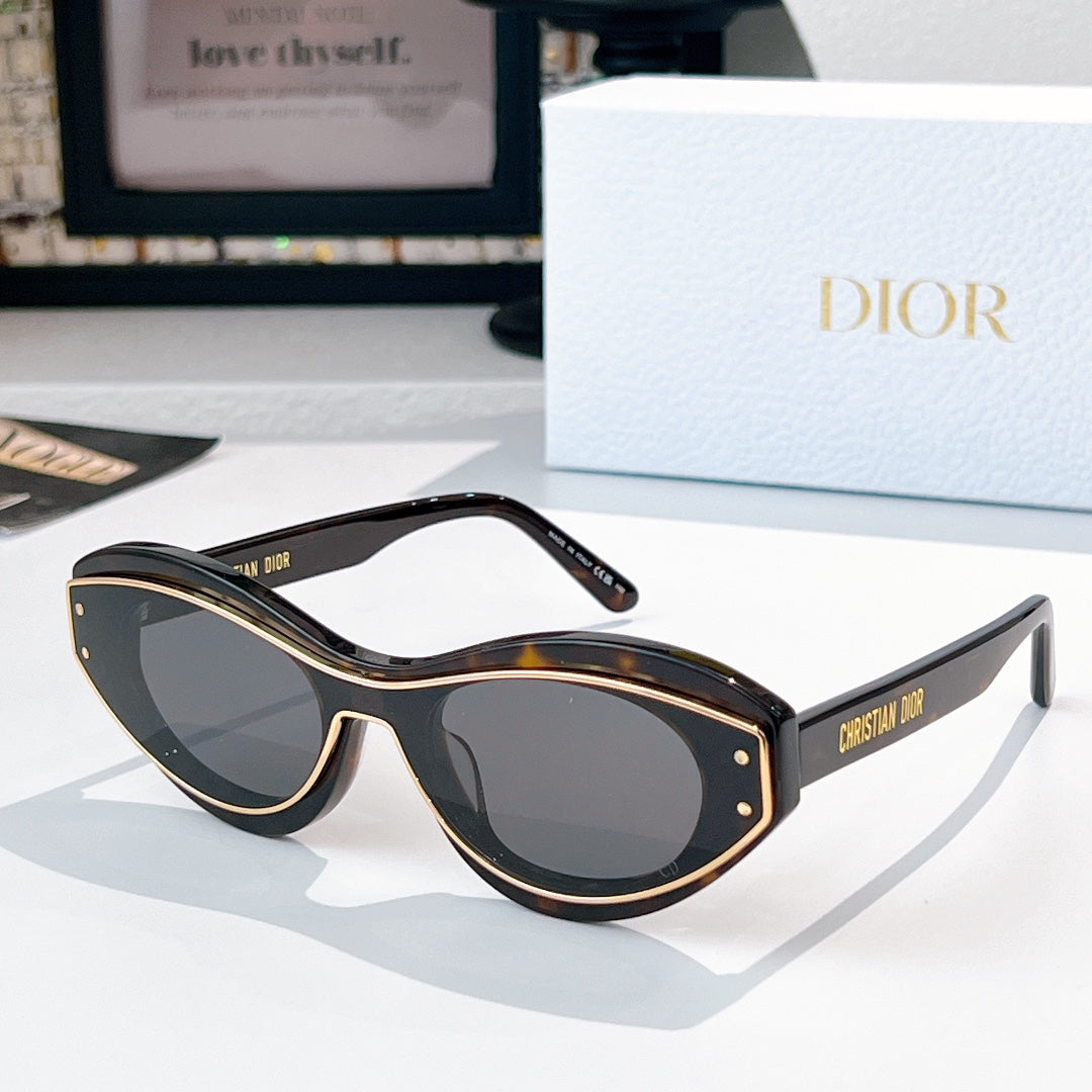 Sunglasses with black frames, gold trim, and dark lenses