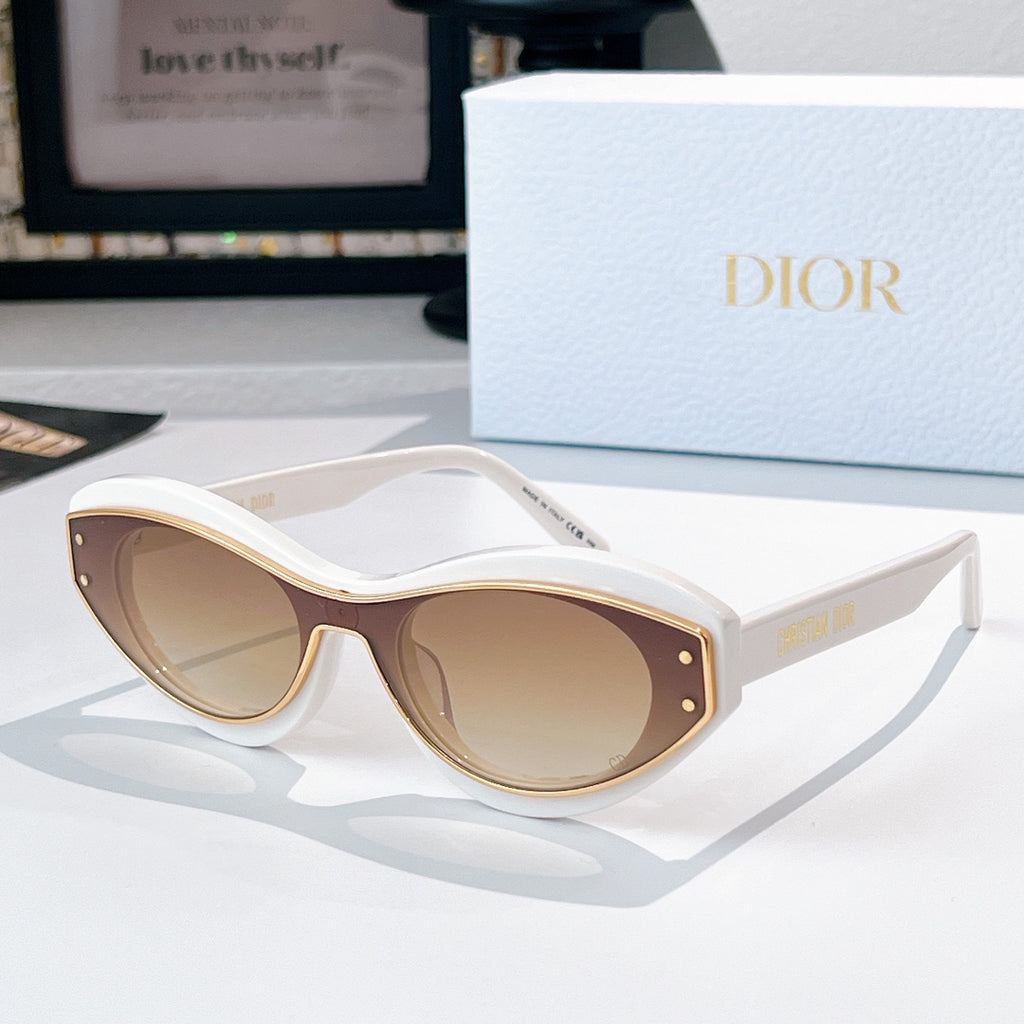 Sunglasses with white frames, gold trim, and light tan lenses