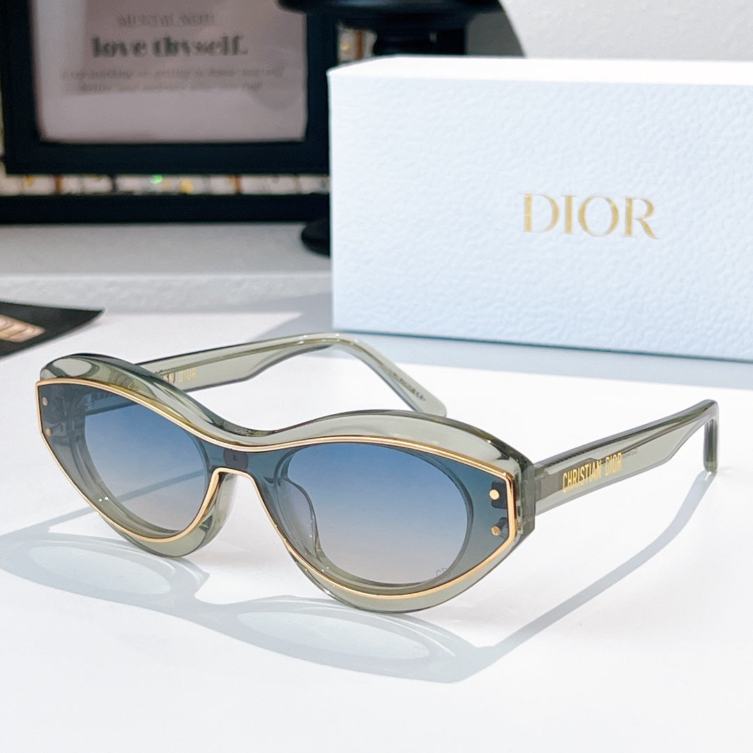 Sunglasses with clear olive frames, gold trim, and blue-tinted lenses