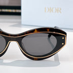 Cat-eye sunglasses with tortoiseshell accents and dark lenses