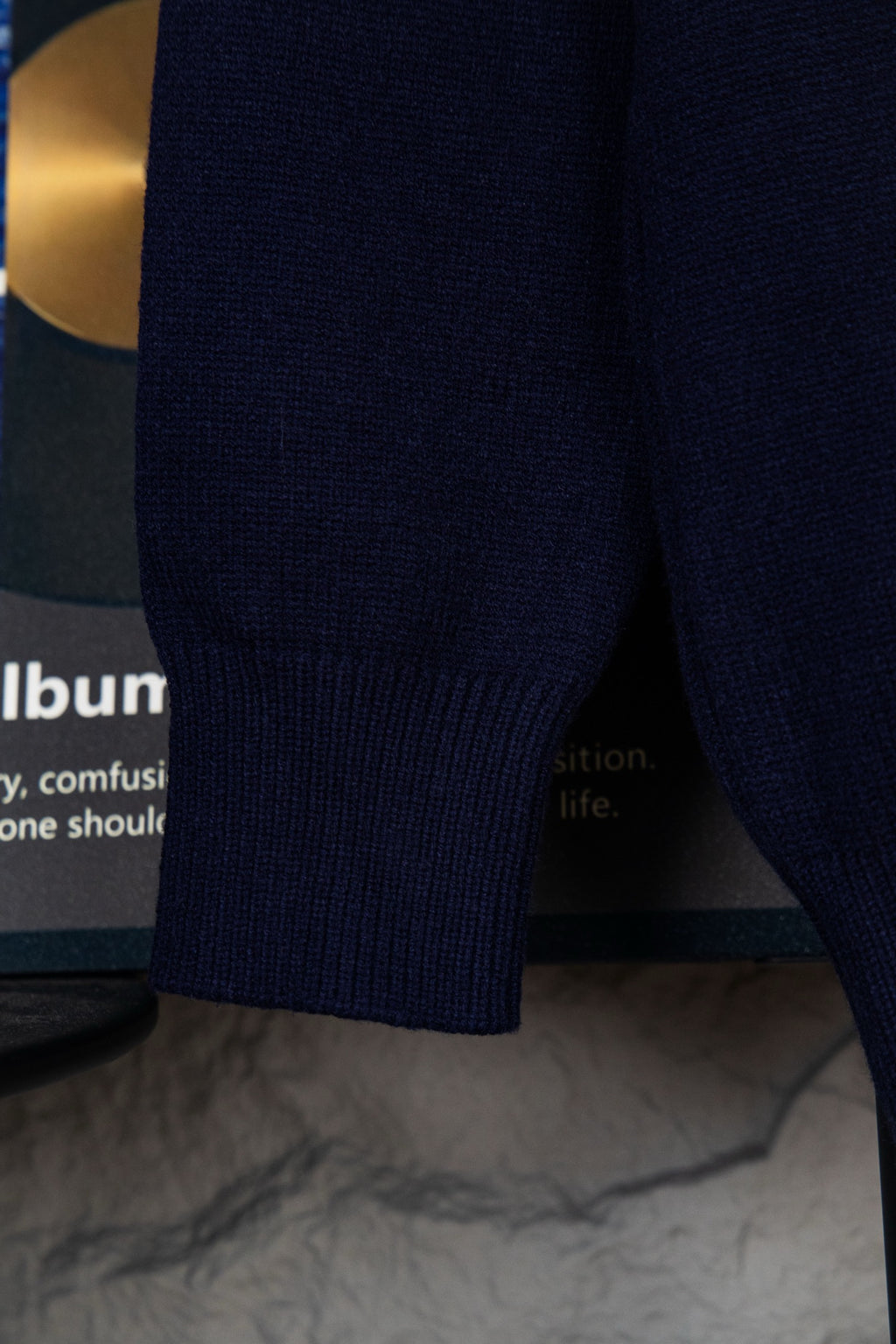 Navy knit polo sweater side hem and sleeve with ribbed knit texture