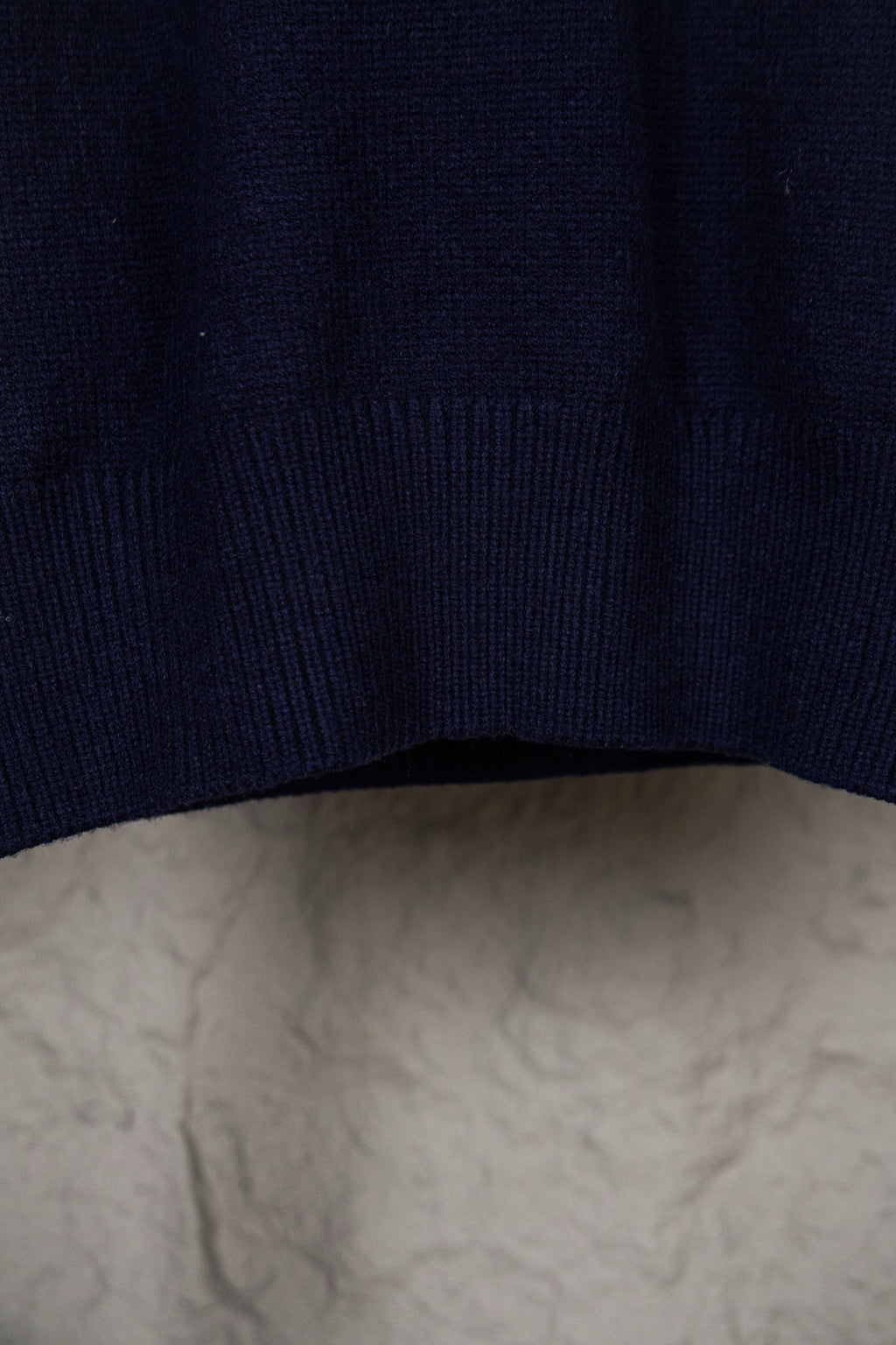 Dark navy knit sweater hem with ribbed cuff detail