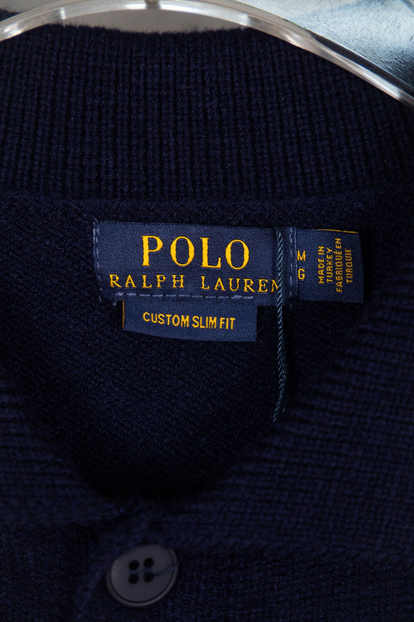 Navy knit polo sweater interior label reading Polo Ralph Lauren Custom Slim Fit