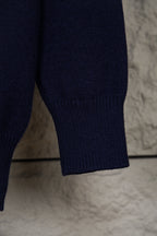 Navy knit polo sweater sleeve cuff with ribbed hem detail
