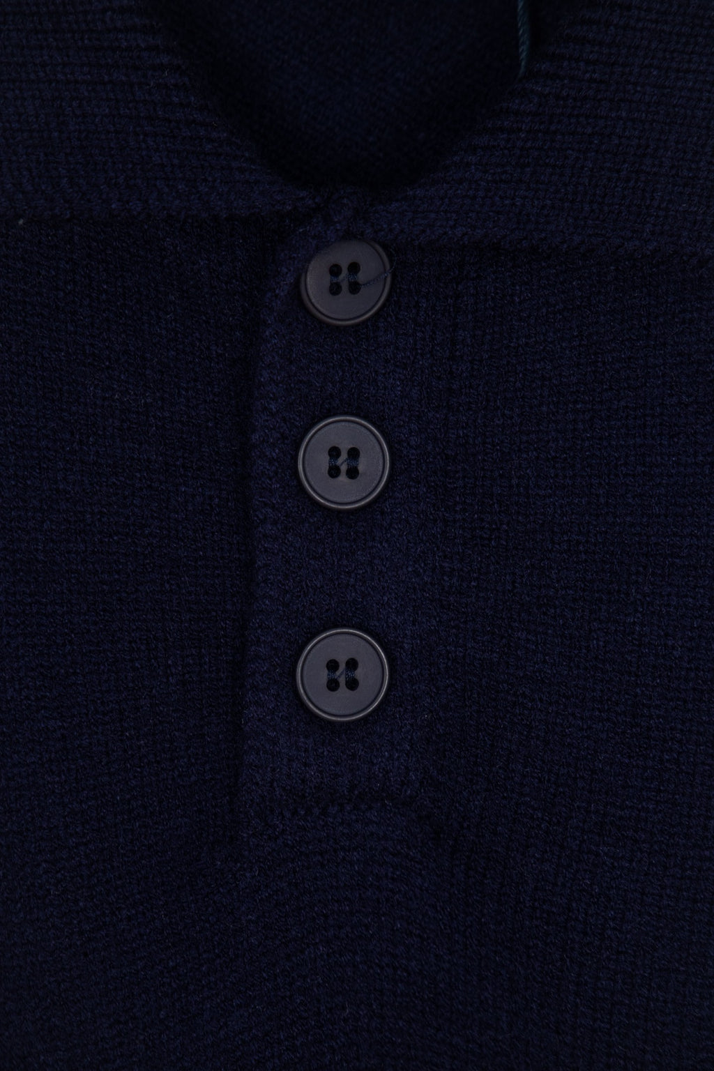 Navy knit polo sweater button placket with three dark buttons