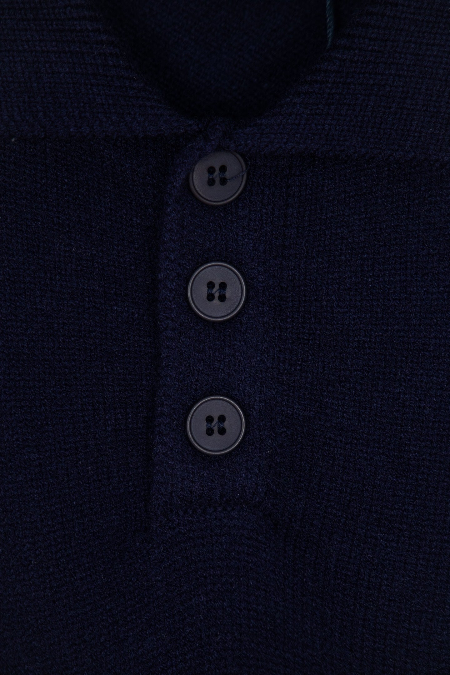 Navy knit polo sweater button placket with three dark buttons
