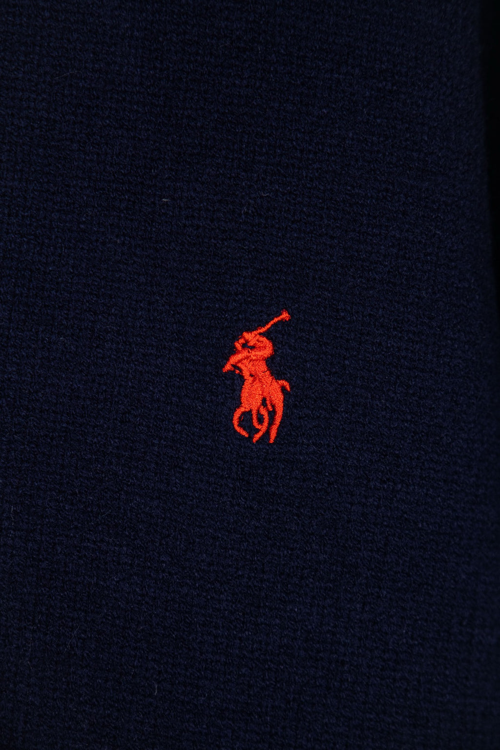 Navy knit polo sweater with small red embroidered logo on chest
