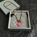 Gold-tone necklace with pink heart, horseshoe and B charms, in jewelry box