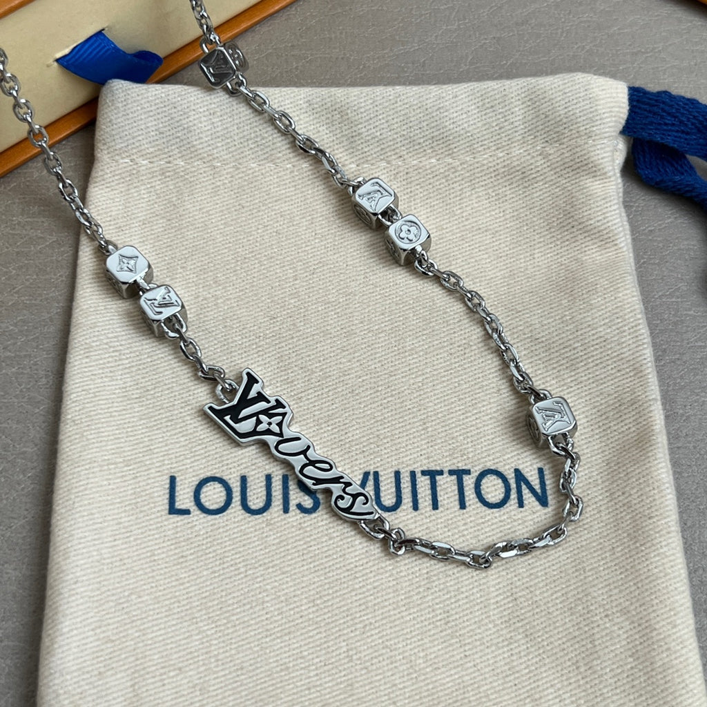 Silver chain necklace with Louis Vuitton logo charm on beige fabric pouch with tag