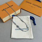 Silver chain necklace with Louis Vuitton logo charm, blue accents, on fabric pouch