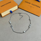 Silver chain necklace with small square charms and Louis Vuitton logo centerpiece