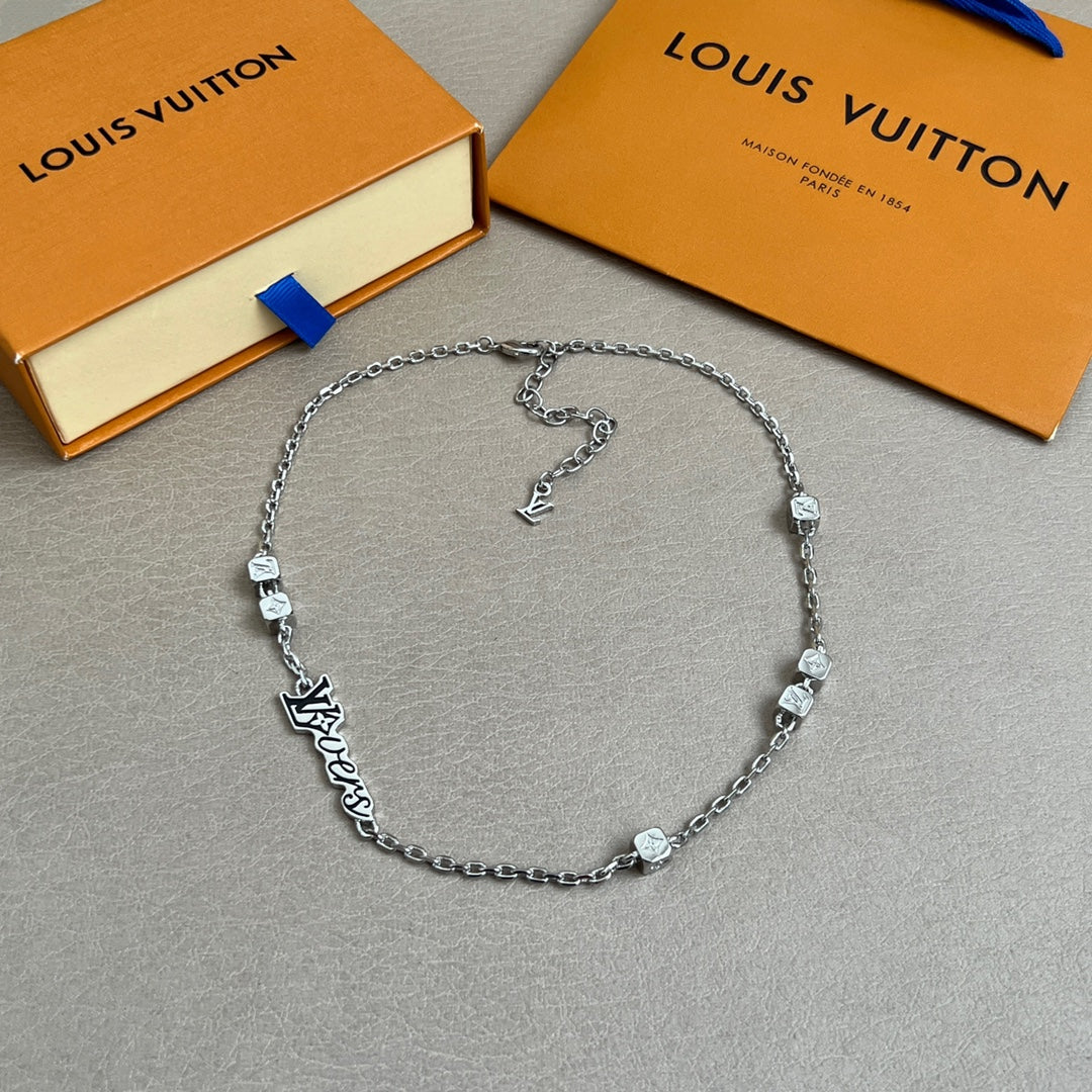 Silver chain necklace with small square charms and Louis Vuitton logo centerpiece