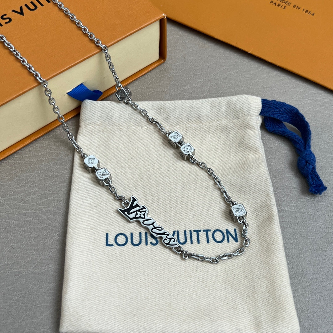 Silver chain necklace with Louis Vuitton logo charm and square links on beige pouch