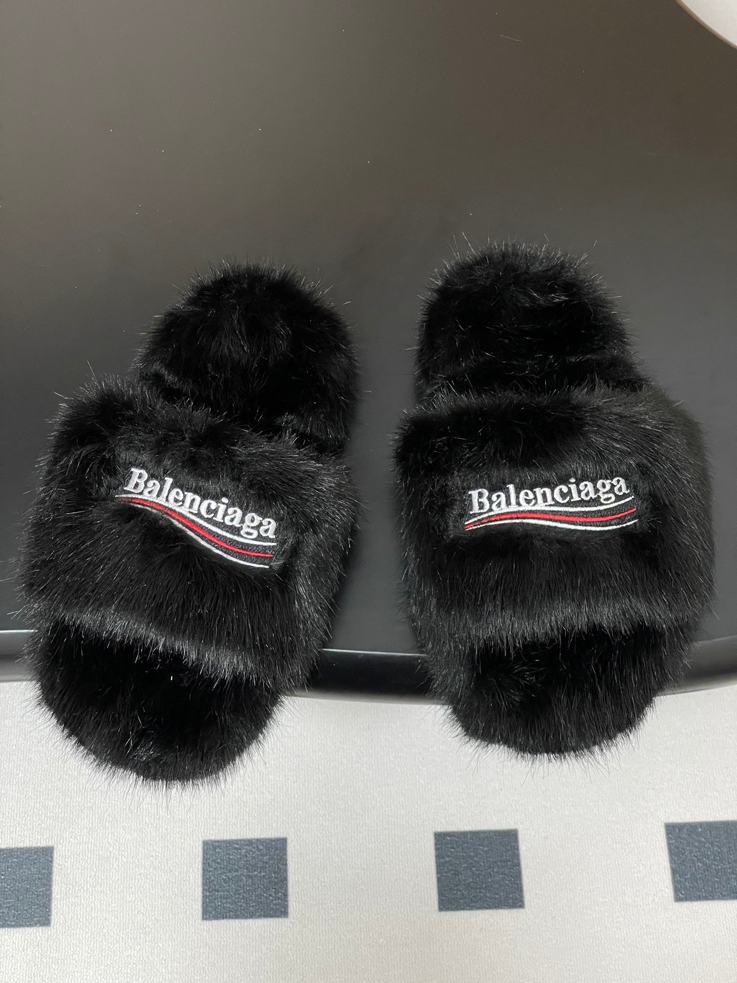 Black faux-fur slide sandals, Balenciaga logo strap across wide band