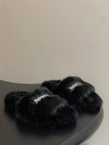 Black fuzzy slide sandals with two wide straps and Balenciaga logo band