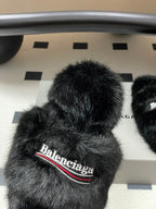 Black fuzzy slide sandal close-up with Balenciaga logo band on front strap