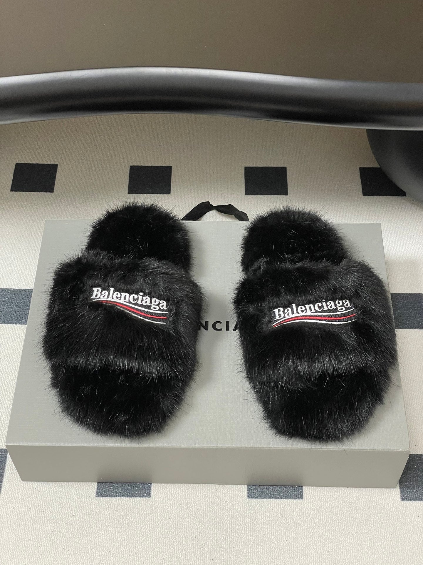 Black faux-fur slide sandals, Balenciaga logo on front strap, pair view