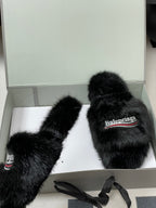 Black faux-fur slide sandals in box with Balenciaga logo on top strap