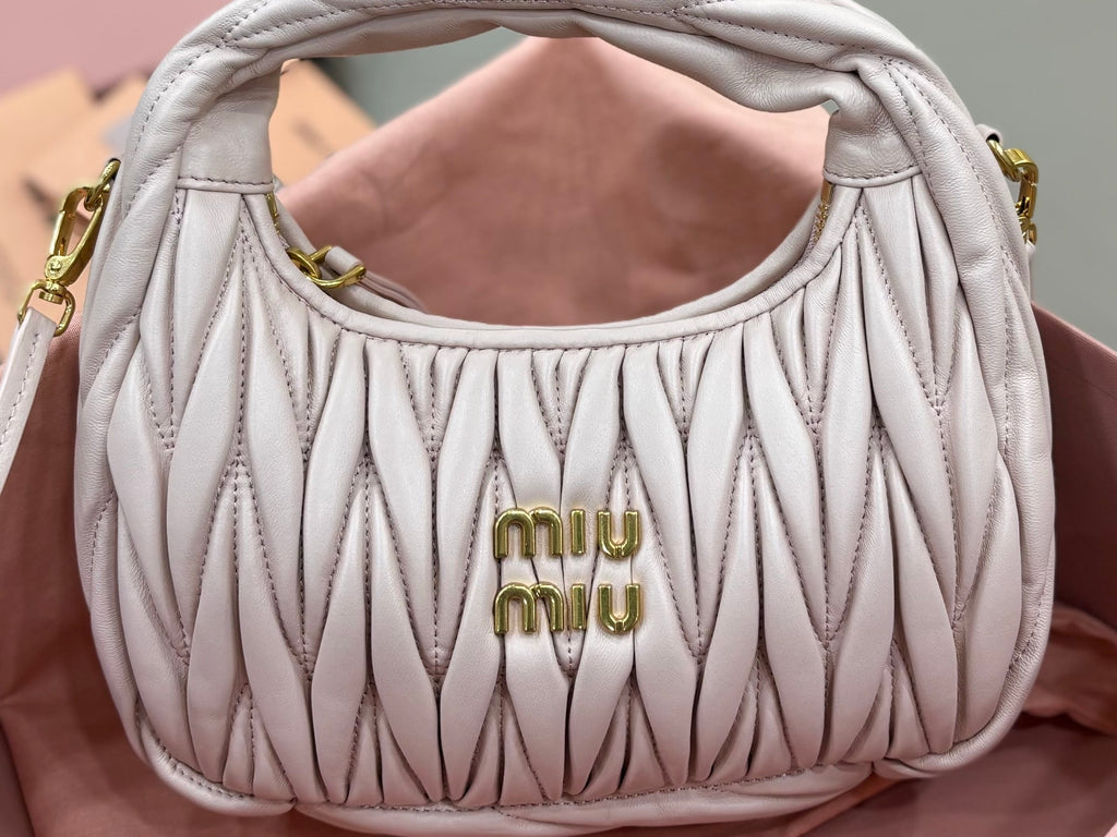 MiuMiu cream quilted hobo bag with gold 'miu miu' logo and curved top handles