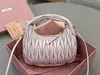 MiuMiu quilted cream hobo bag with gold-tone top handles and side straps