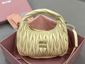 MiuMiu ruched mini hobo bag in pale yellow leather with top handle and logo