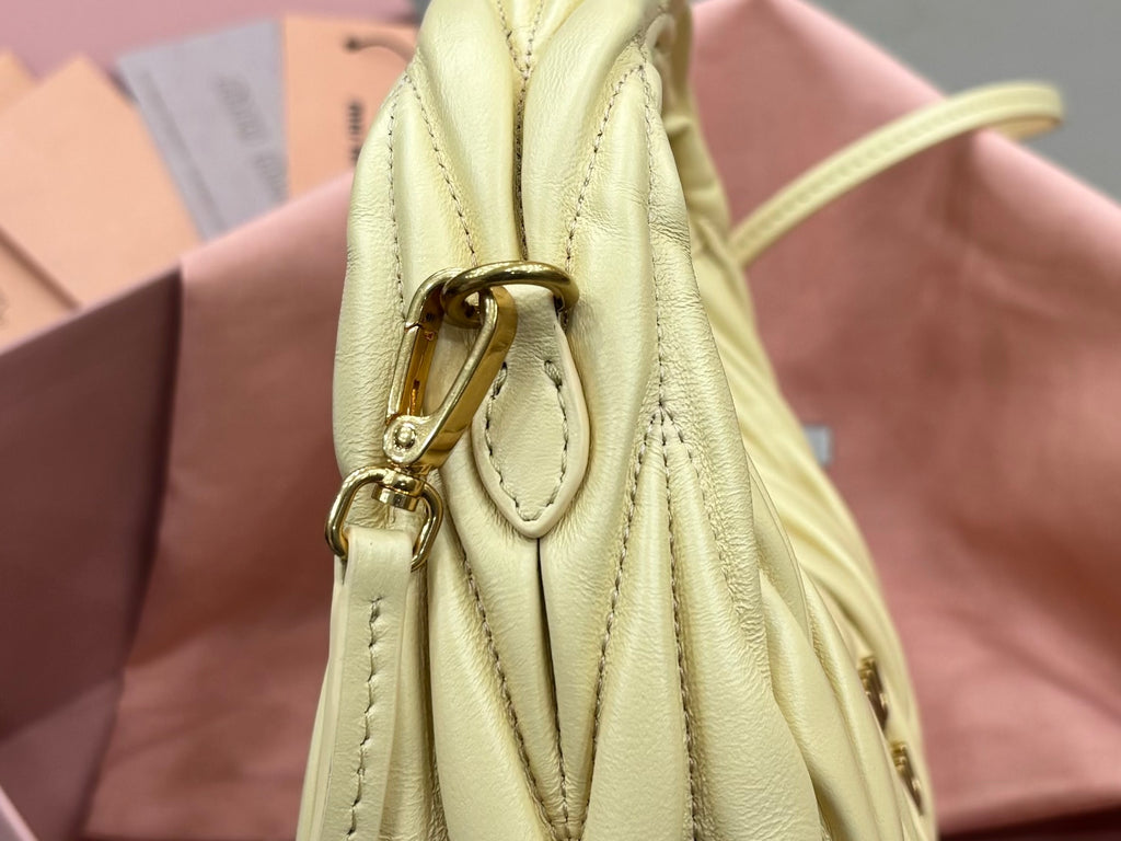 MiuMiu pale yellow leather mini bag with gold clasp and braided strap attachment