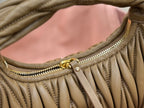 MiuMiu olive green hobo bag close-up of top edge trim and gold zipper pull