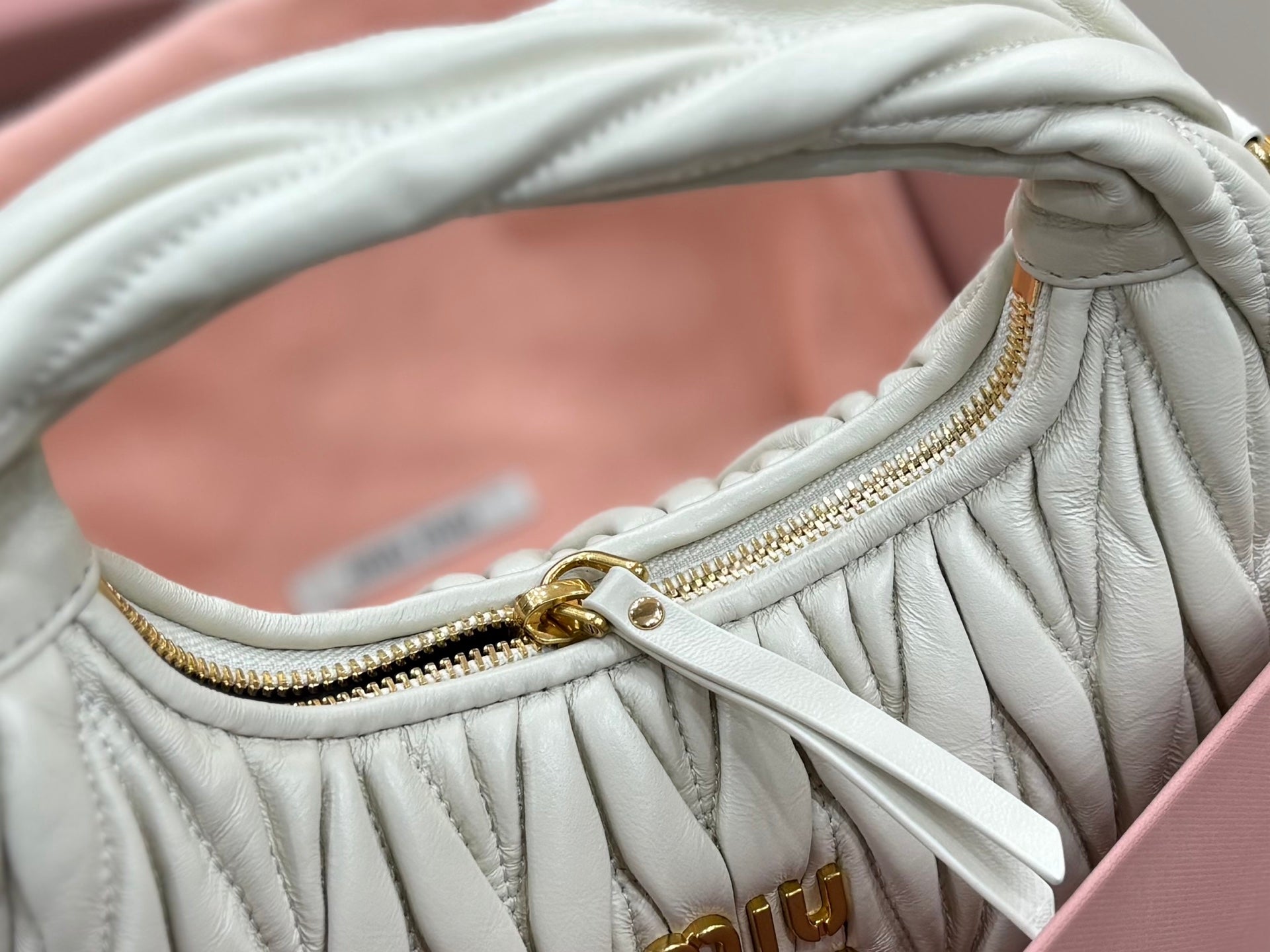 MiuMiu light mint quilted hobo bag zipper trim and top edge close-up