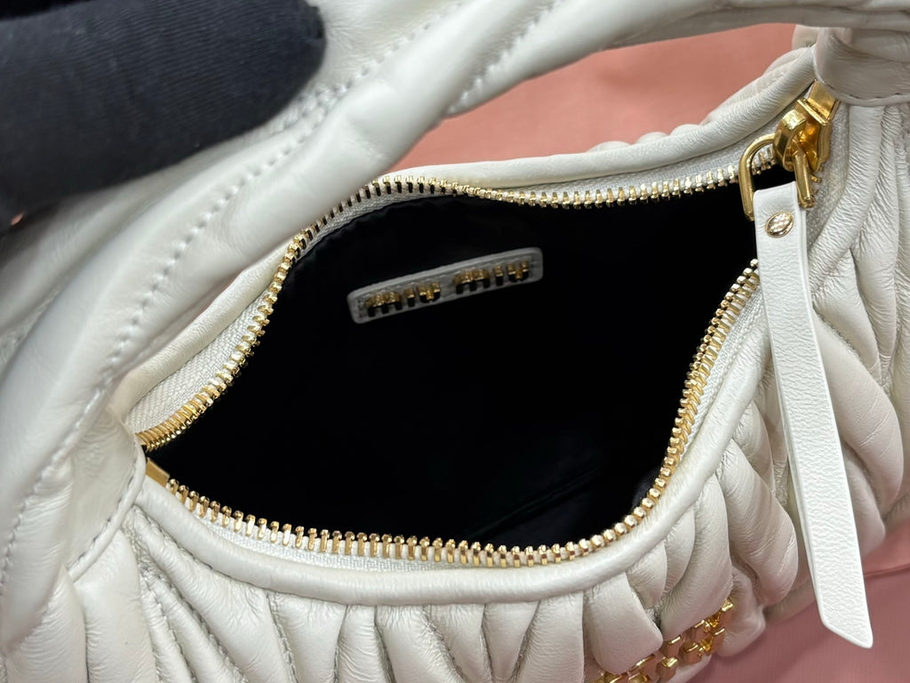 MiuMiu light mint hobo bag interior with zip pocket and gold zipper