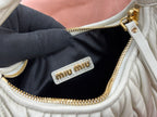 MiuMiu light mint hobo bag interior tag with miu miu logo on zip pocket lining