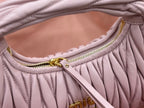 Lavender mini handbag interior opening with gold zipper and braided trim detail