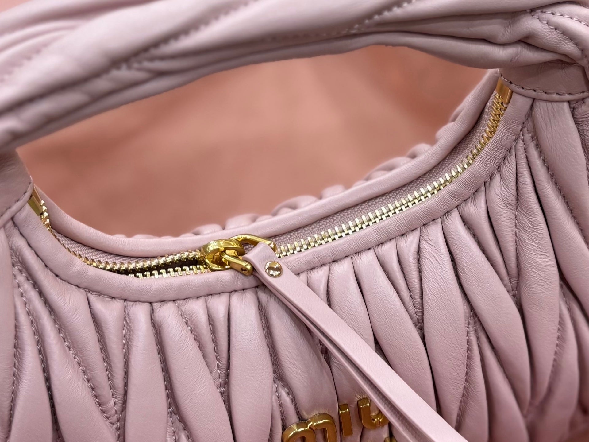 Lavender mini handbag interior opening with gold zipper and braided trim detail
