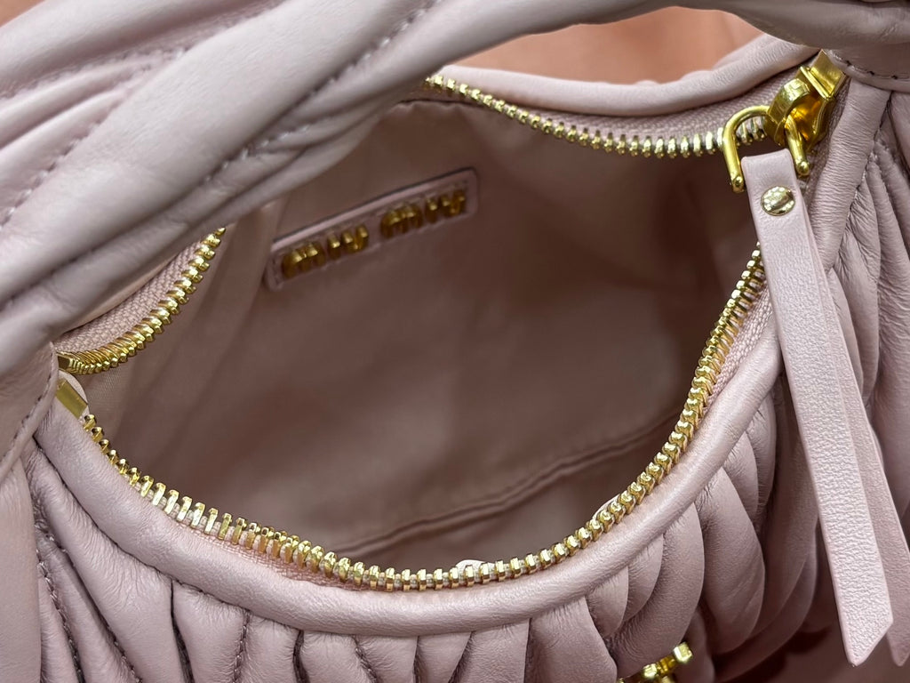 Lavender mini handbag interior with gold zipper chain and snap pocket details