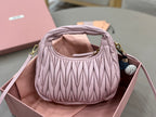 Lavender mini ruched handbag with top handle, gold hardware, hanging pom-pom charm