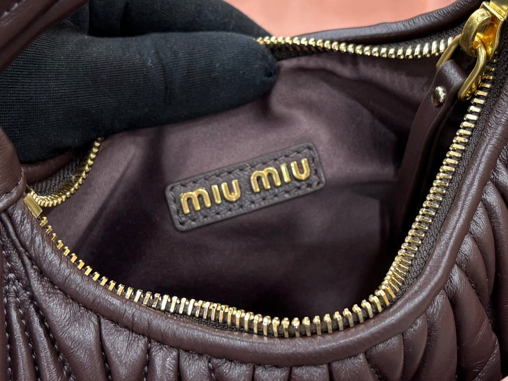 MiuMiu brown mini bag interior lining with “miumiu” logo label