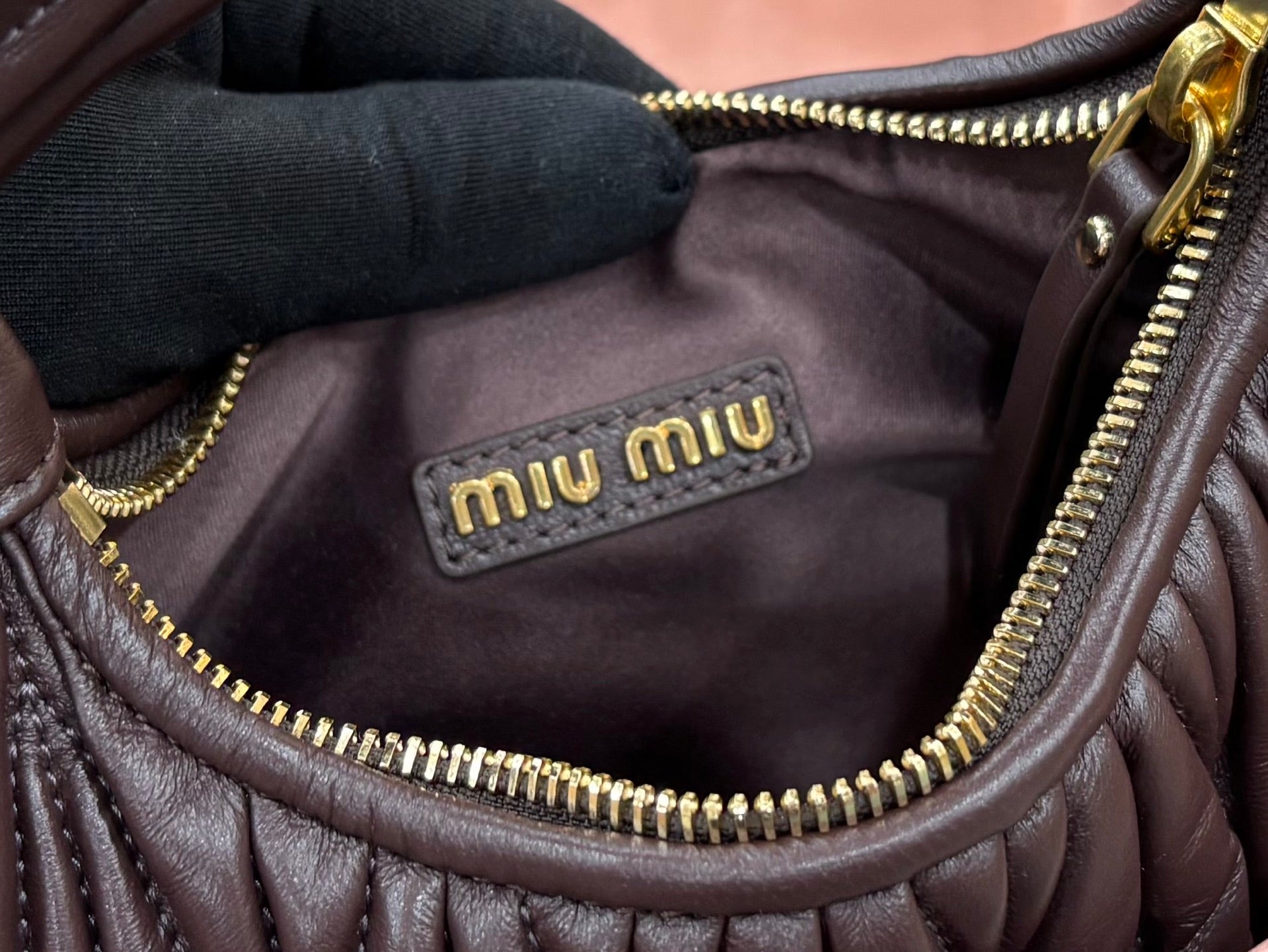 MiuMiu brown mini bag interior lining with “miumiu” logo label